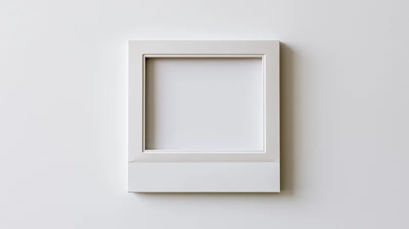 Blank white polaroid frame lying flat on a plain surface