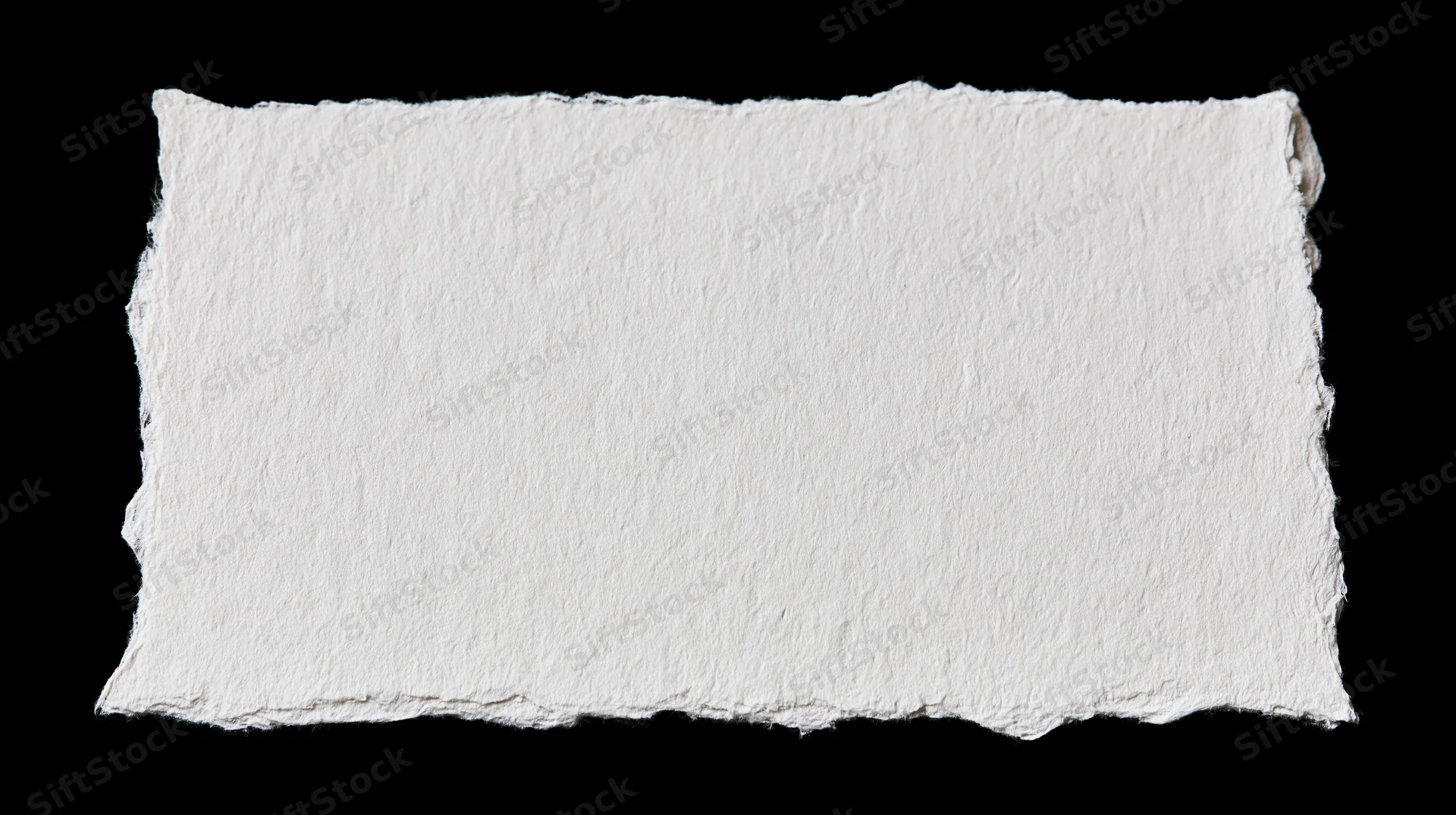 White handmade paper with torn edges isolated on black background