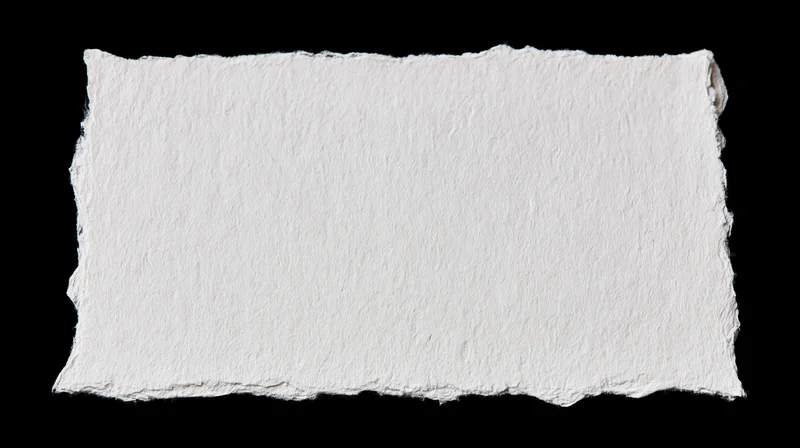 White handmade paper with torn edges isolated on black background