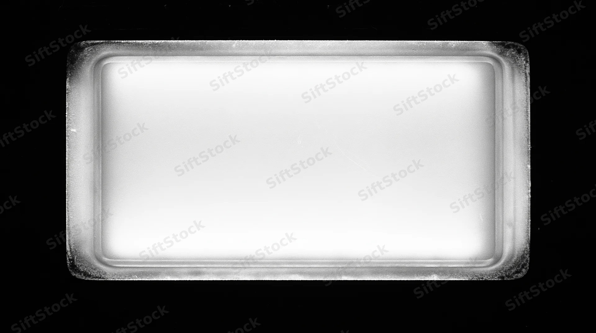 Overexposed blank film frame centered on pure black background