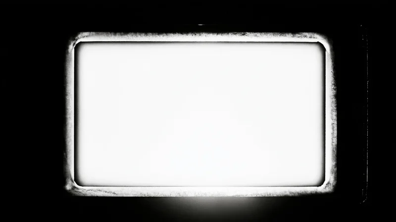 Overexposed blank film frame centered on black background with textured border