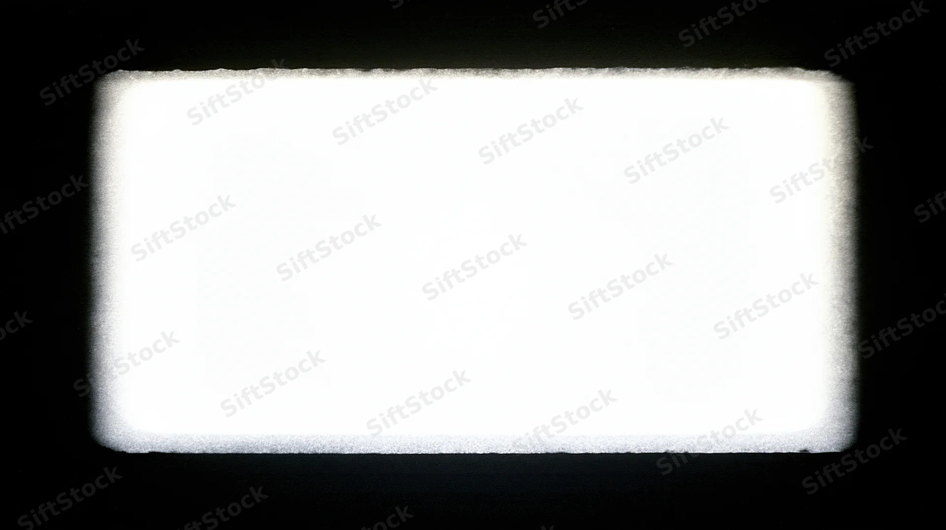 Overexposed blank film frame centered on black background with soft glowing edges