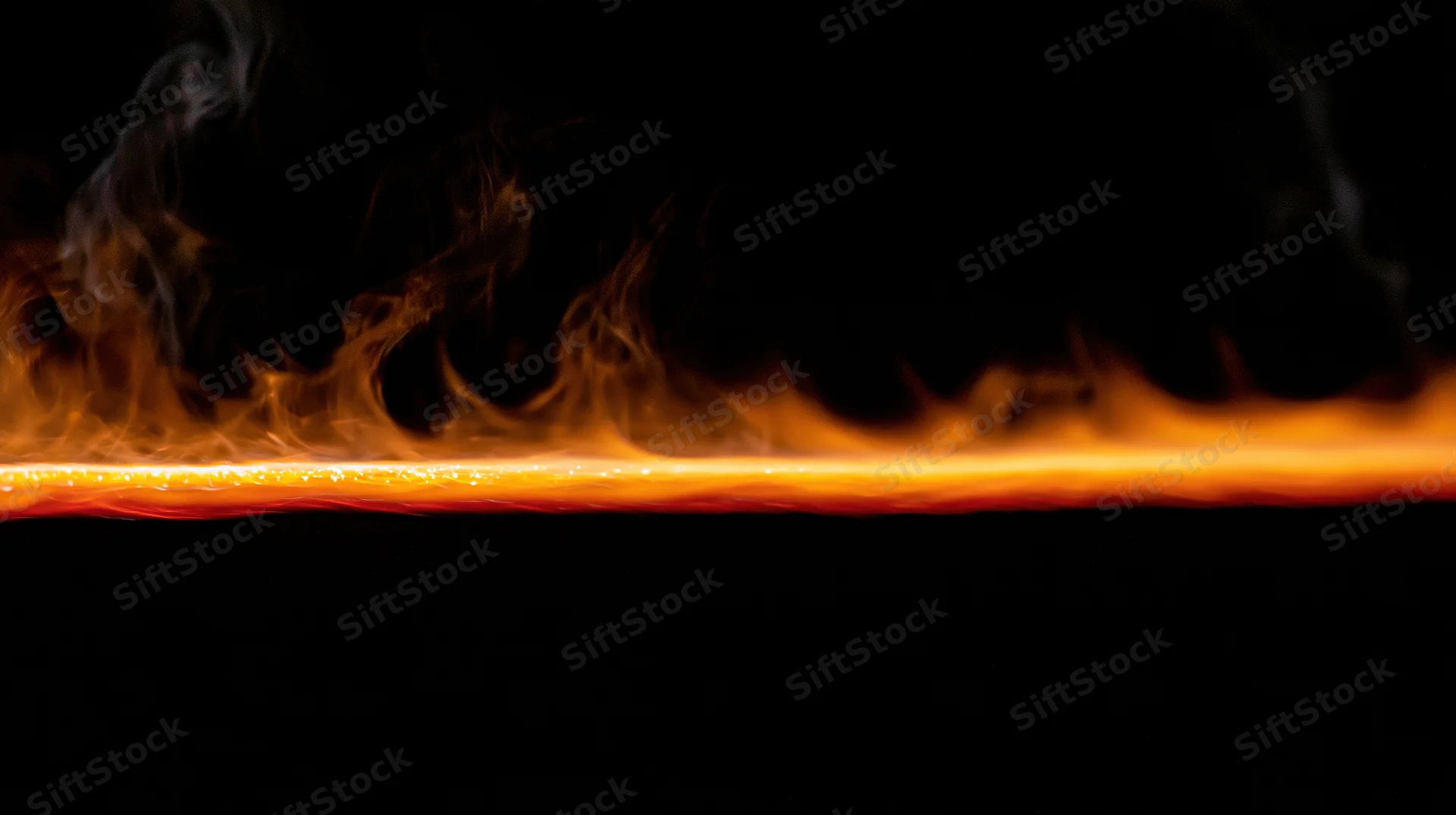 Horizontal line of fire burning across dark background with rising smoke