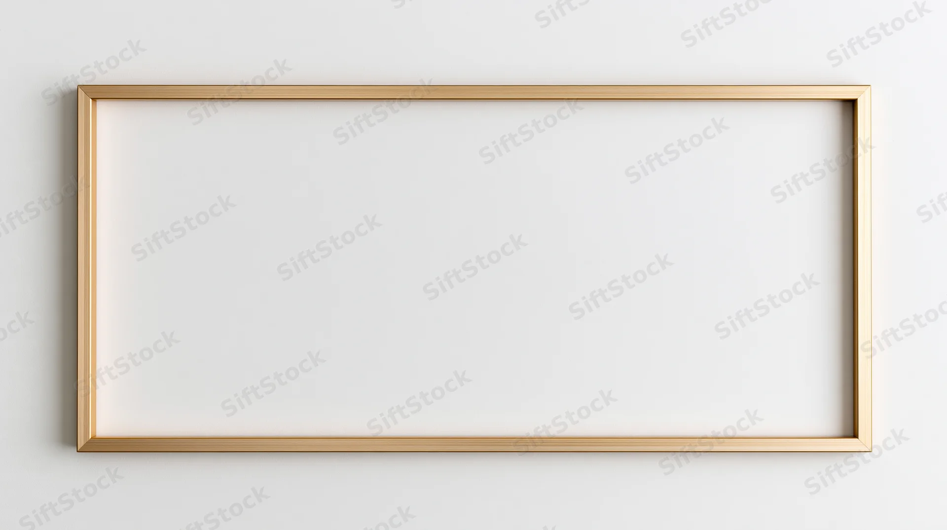 Thin gold rectangular frame lying flat on a white surface with blank interior for mockup use