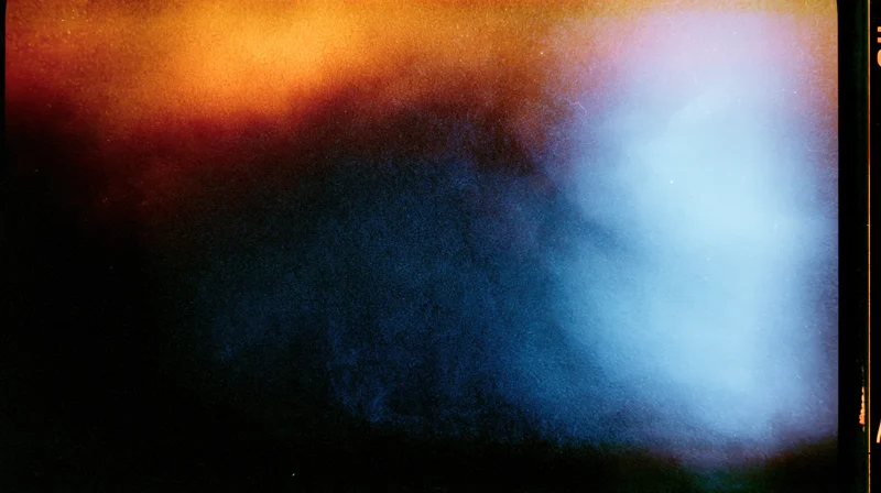 Abstract film texture with color gradient and grainy haze