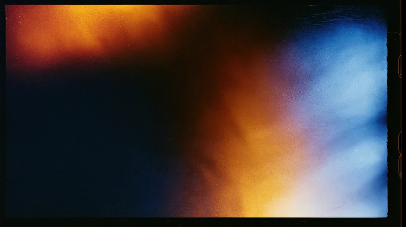 Abstract film texture with warm and cool color gradients on a blank exposed frame