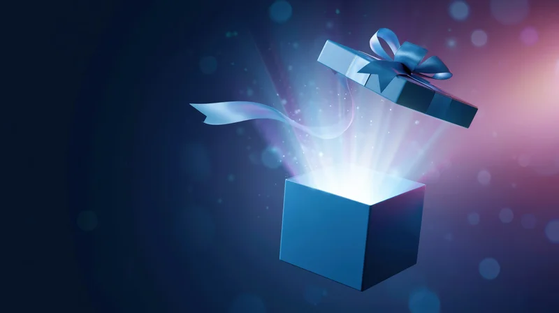Open blue gift box with lid floating above and glowing light emerging from inside against dark gradient background with bokeh