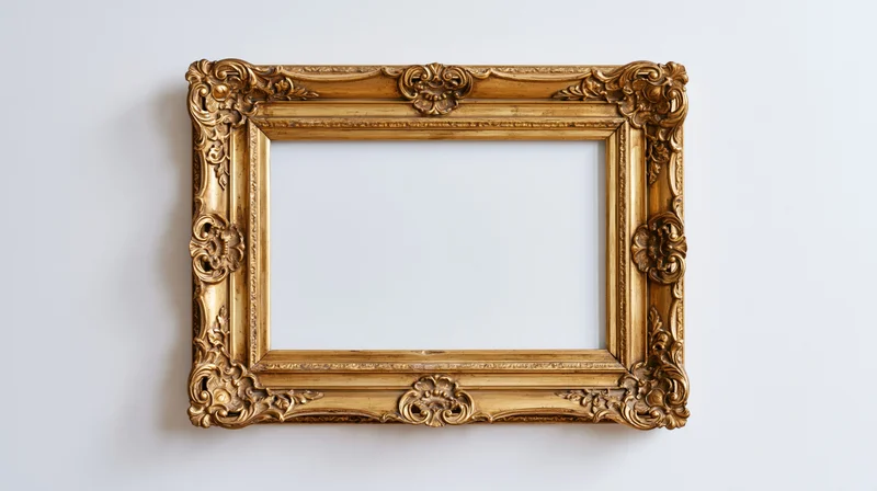 Ornate gold baroque frame with floral carvings hanging on white wall