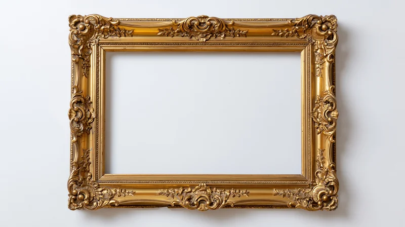Ornate gold baroque frame with carved floral details hanging on a white wall