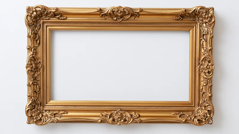 Ornate gold baroque frame with floral carvings hanging on a white wall