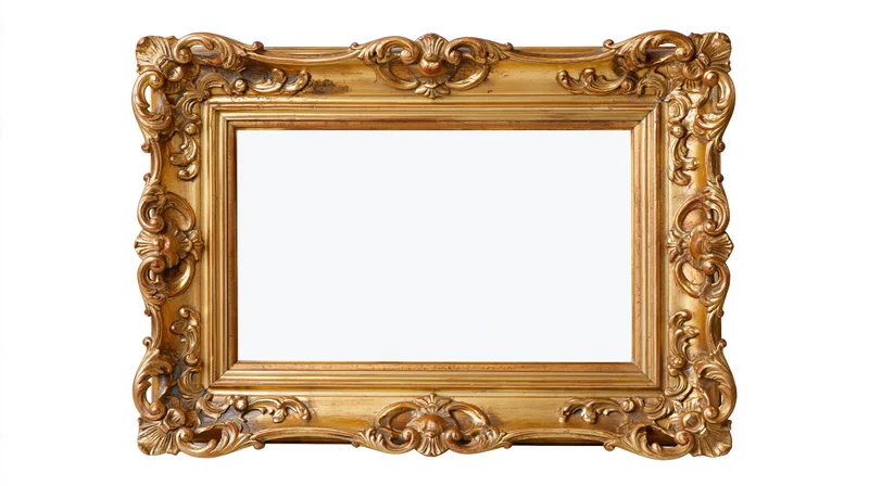 Ornate antique gold picture frame with baroque carved scrollwork isolated on white background