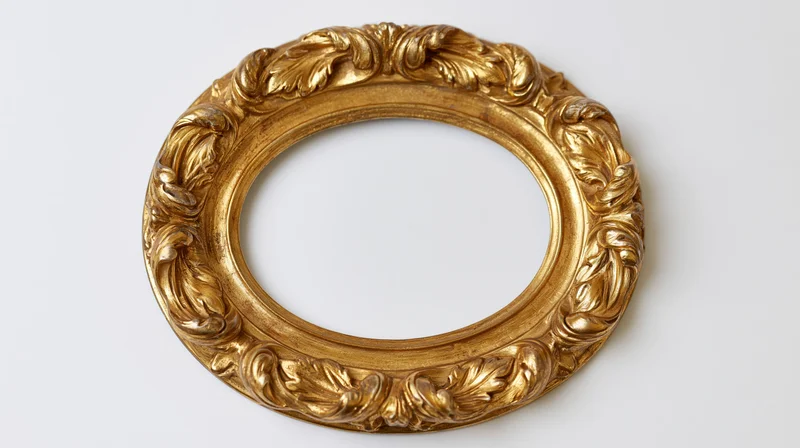 Ornate antique oval frame with baroque carved leaf details on white background