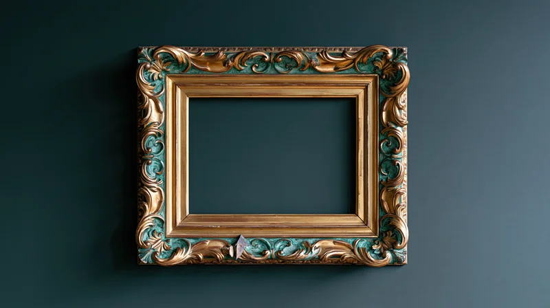Ornate baroque frame with gold and patinated teal details hanging on dark wall