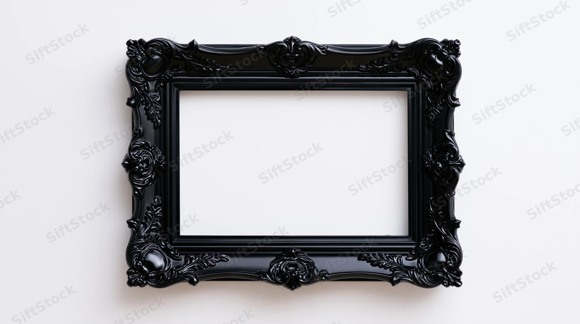 Ornate black baroque-style frame hanging on a white wall with empty center for display