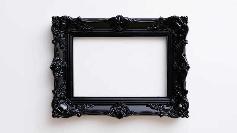 Ornate black baroque-style frame hanging on a white wall with empty center for display