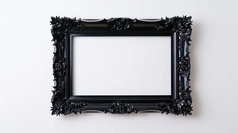 Ornate black gothic baroque frame with intricate carvings hanging on a white wall