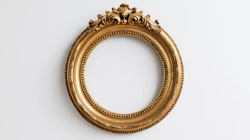 Ornate gold circular frame with baroque carvings hanging on a white wall