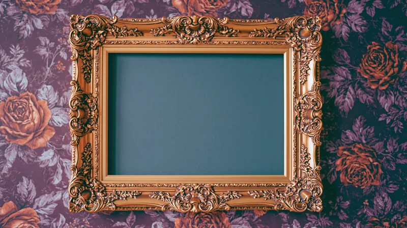 Ornate gold baroque frame with carved detailing hanging on floral wallpapered wall