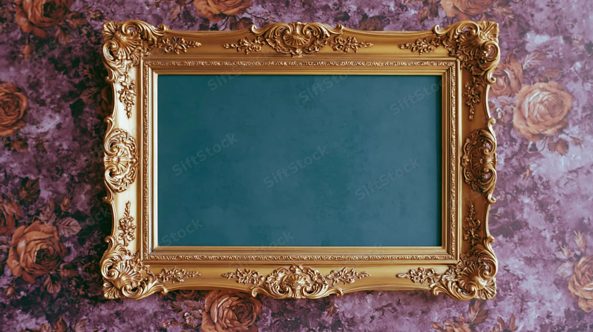 Ornate gold baroque frame with intricate carvings mounted on floral purple wallpaper