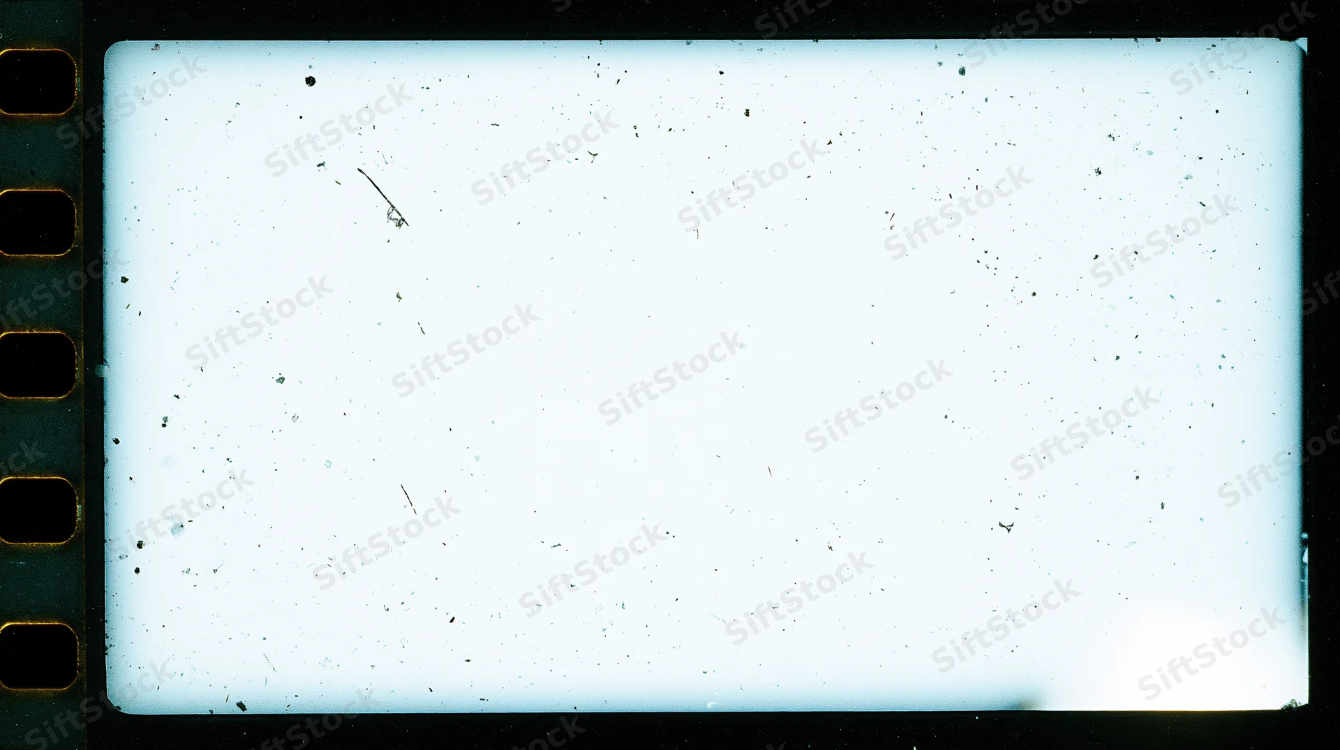 Overexposed blank 16mm film frame with speckles and sprocket holes on black background