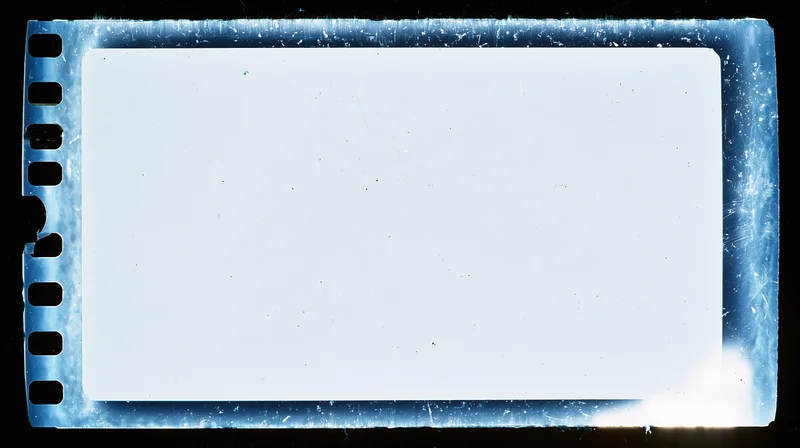 Blank overexposed 16mm film frame with perforated edges on black background