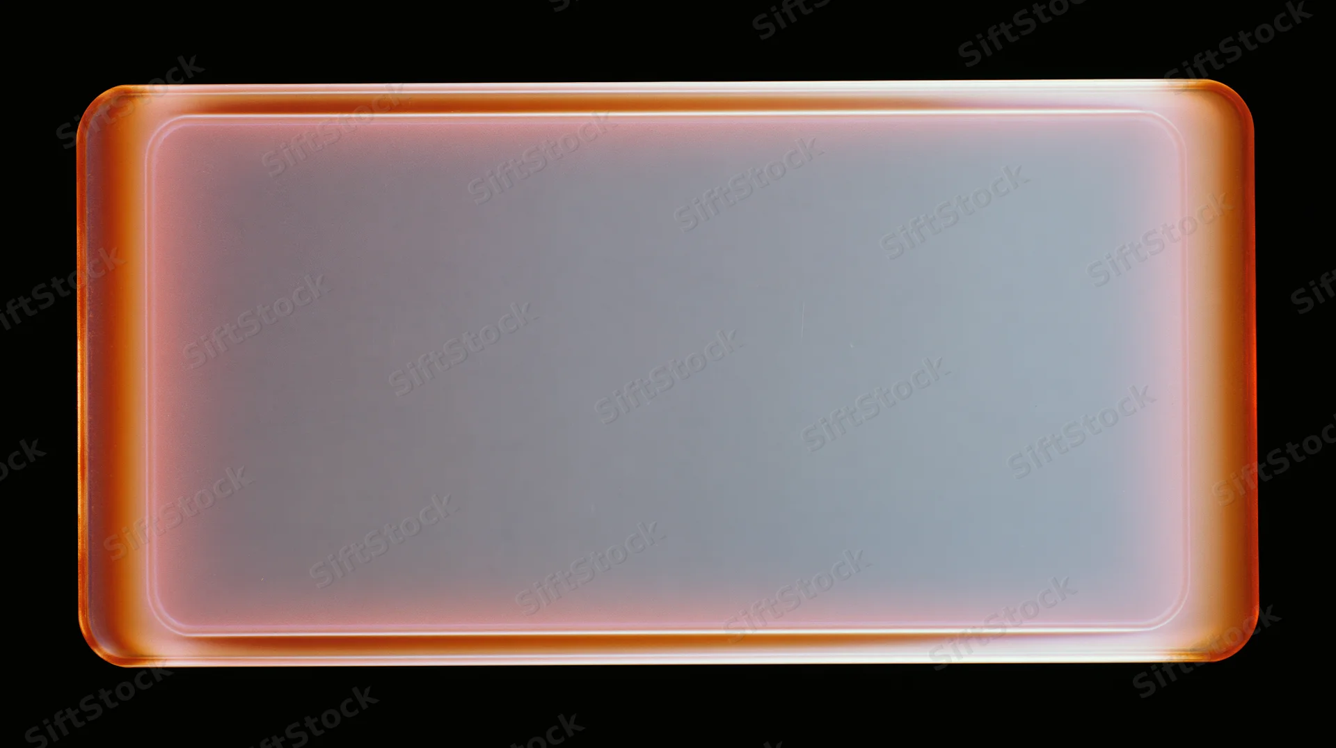 Blank overexposed analog film frame with orange glow on black background