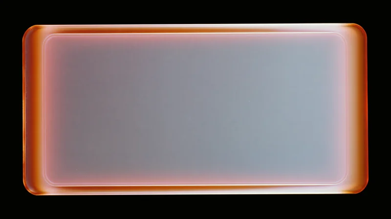 Blank overexposed analog film frame with orange glow on black background