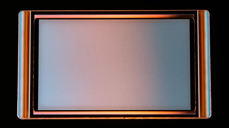 Blank overexposed analog film frame with metallic border on black background