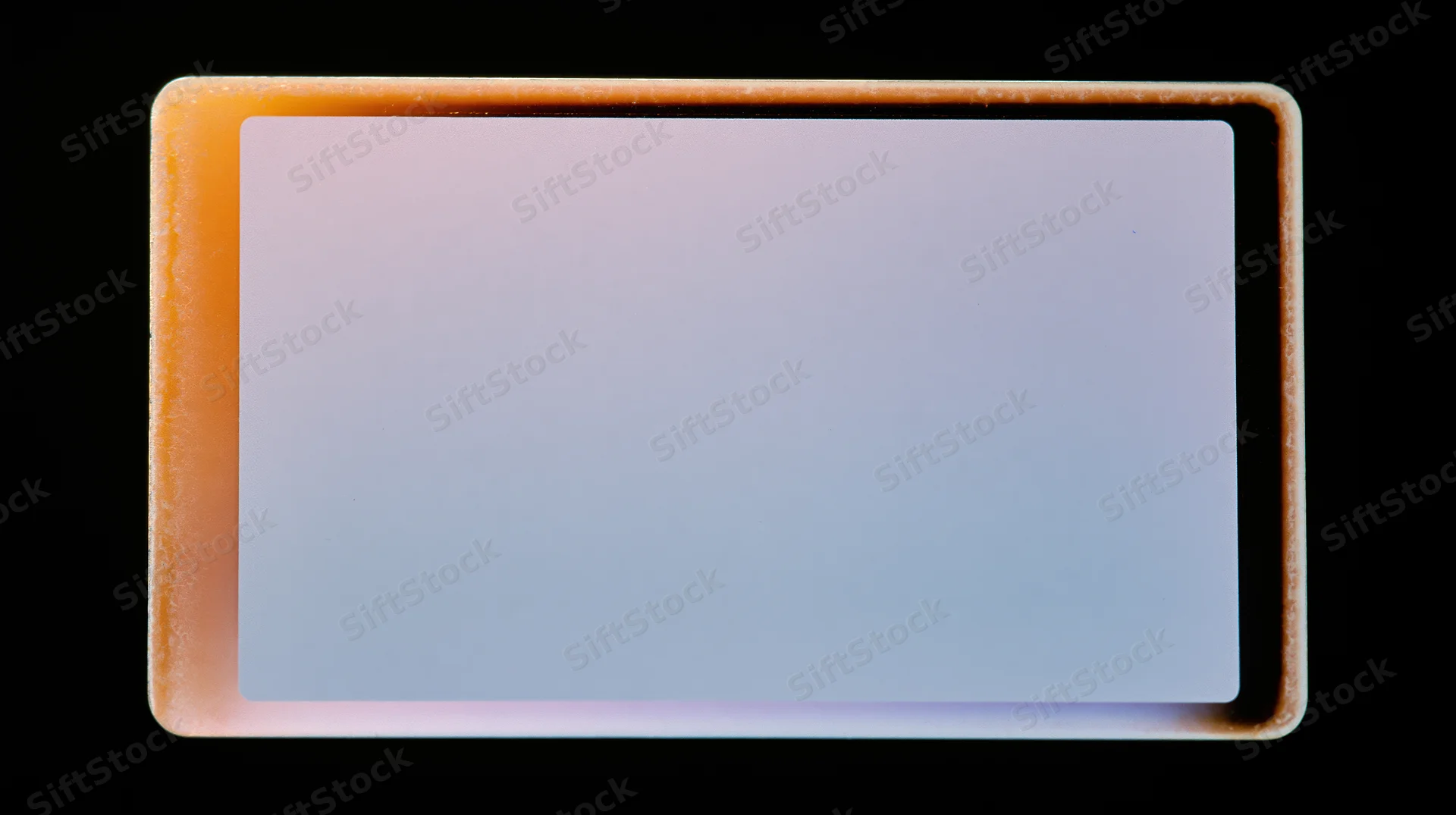 Blank overexposed analog film frame with orange border on black background
