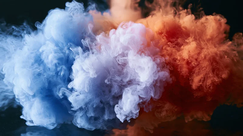 Blue and red ink clouds colliding and dispersing in water against a dark background