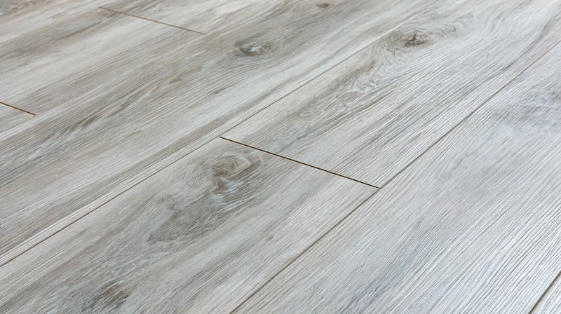 Diagonal close-up of grey laminate wood-effect flooring planks