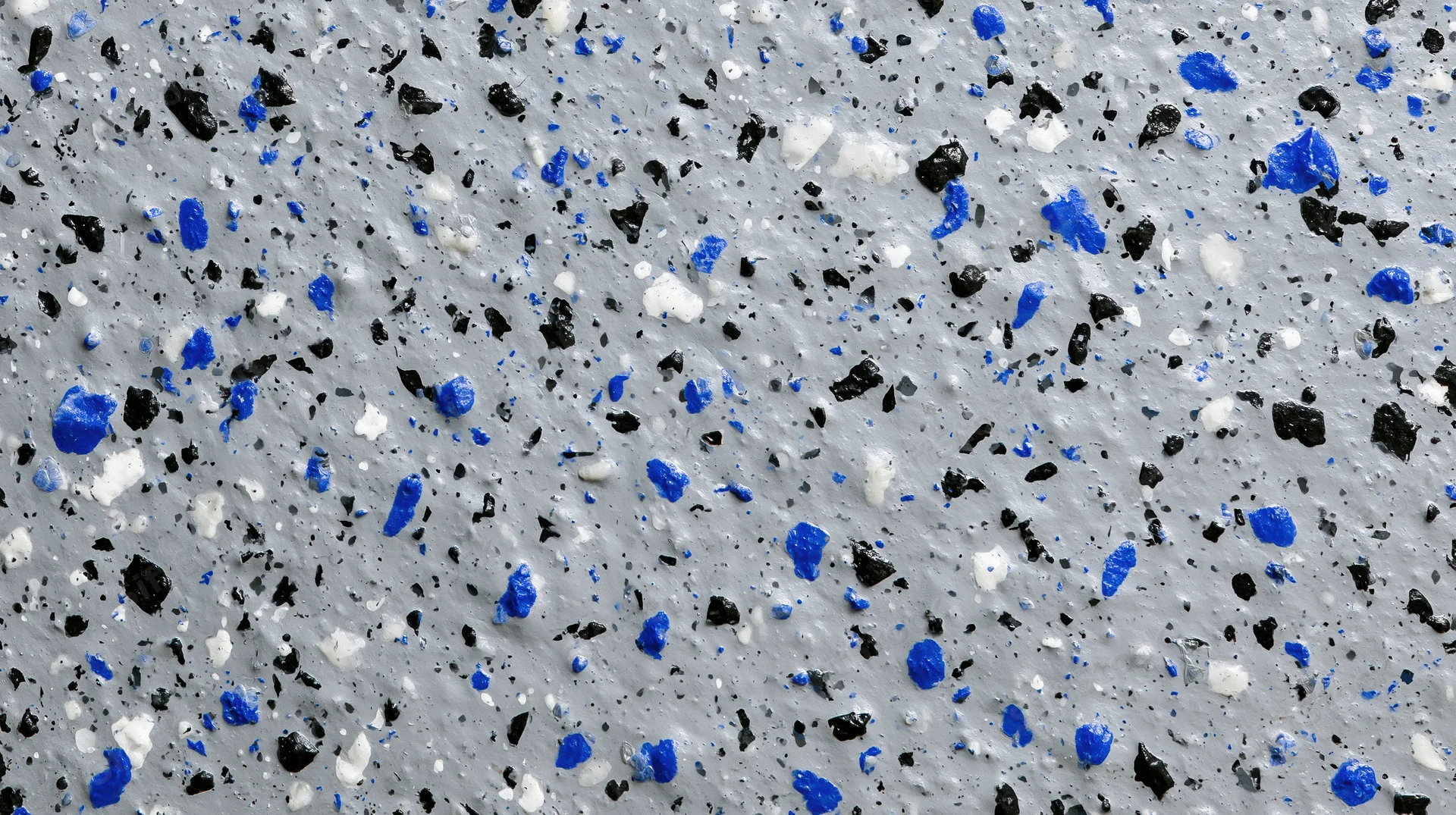 Close-up of grey epoxy floor with blue black and white speckles