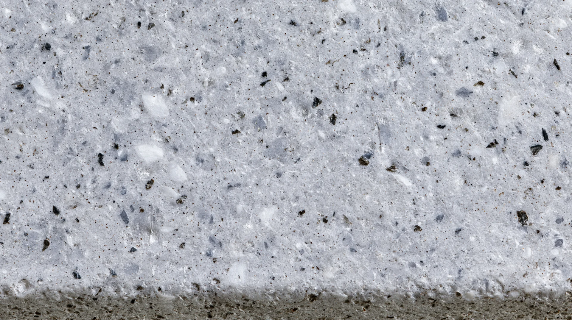 Close-up of polished concrete terrazzo surface with embedded aggregate and speckled texture