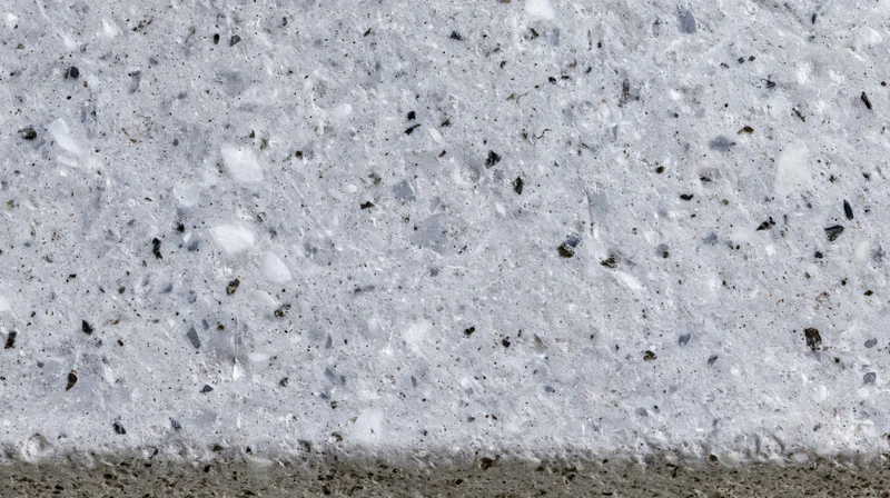 Close-up of polished concrete terrazzo surface with embedded aggregate and speckled texture