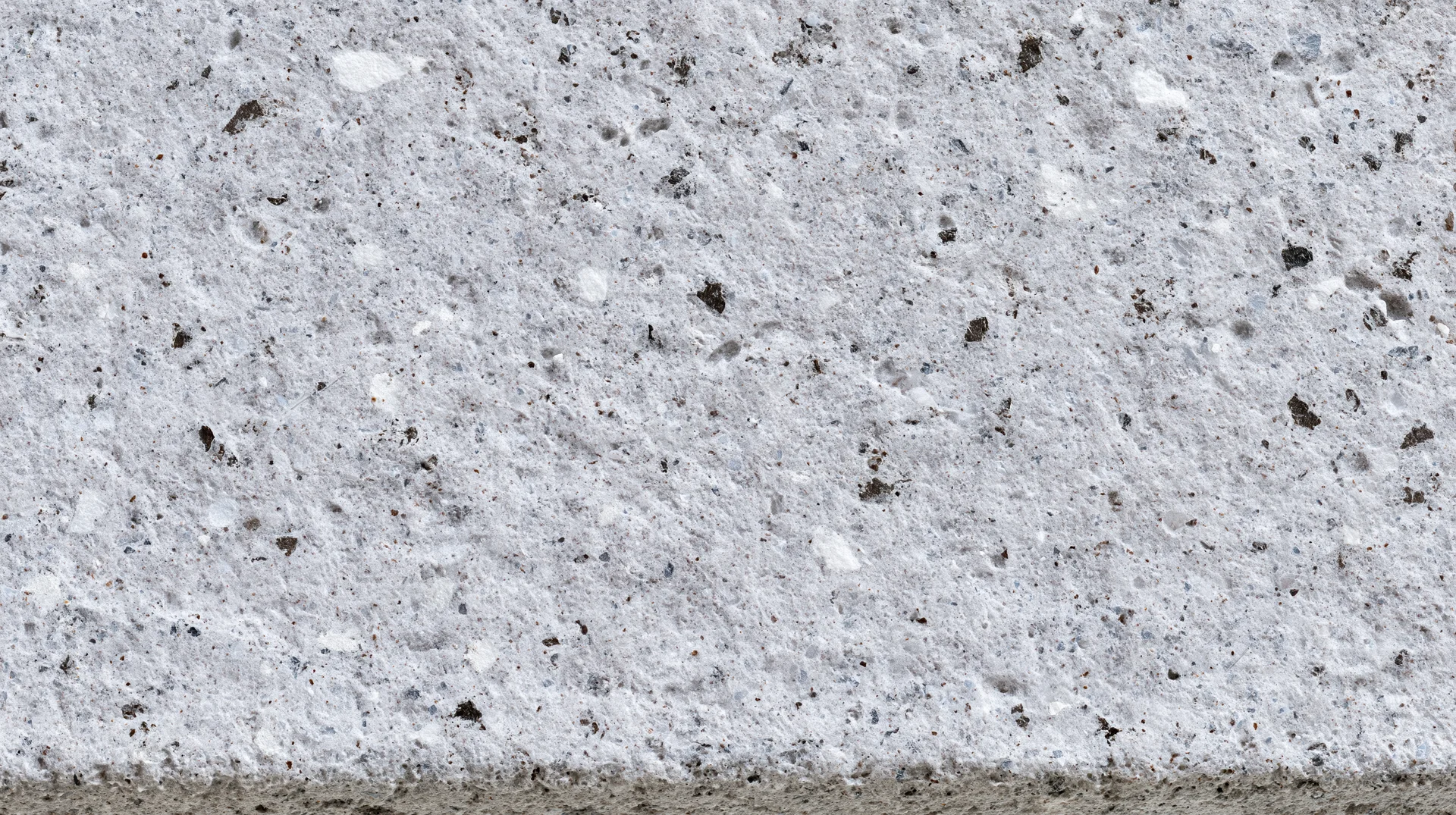 Close-up of a polished concrete terrazzo surface with embedded stone aggregates