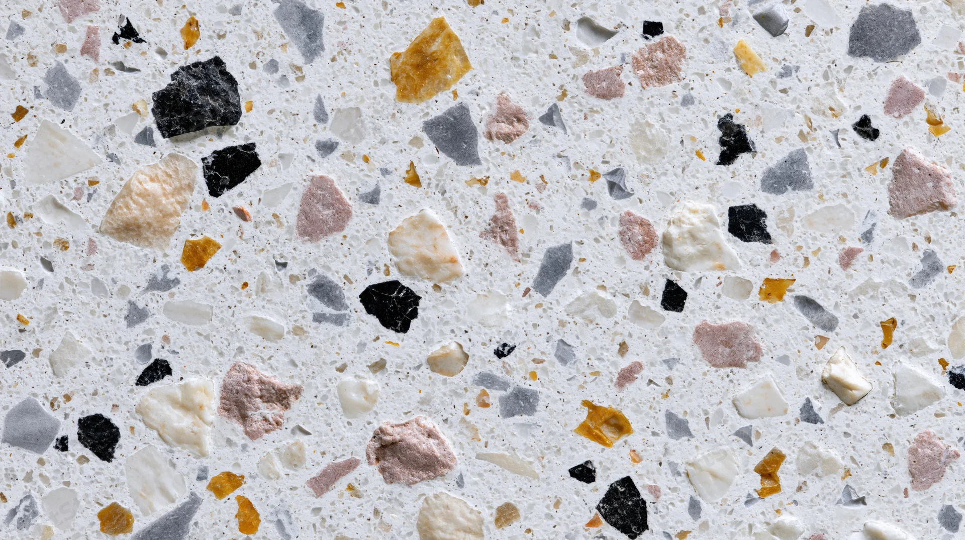Close-up of terrazzo floor surface with embedded stone fragments in white and multicolored tones