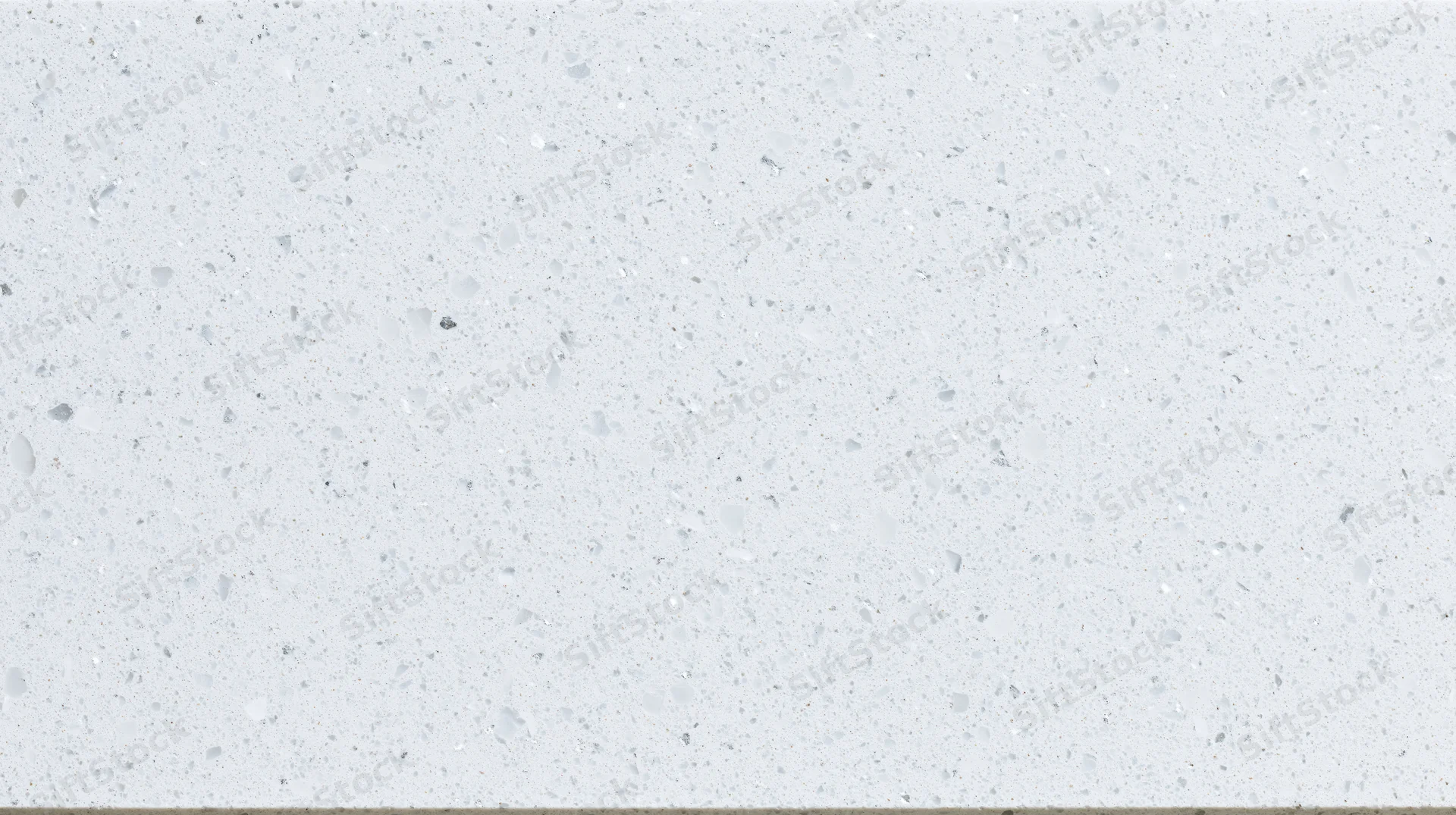 Close-up of white terrazzo composite surface with speckled texture for kitchen or bathroom use