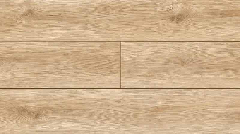Close-up of light oak laminate flooring planks laid in a staggered pattern on a flat surface