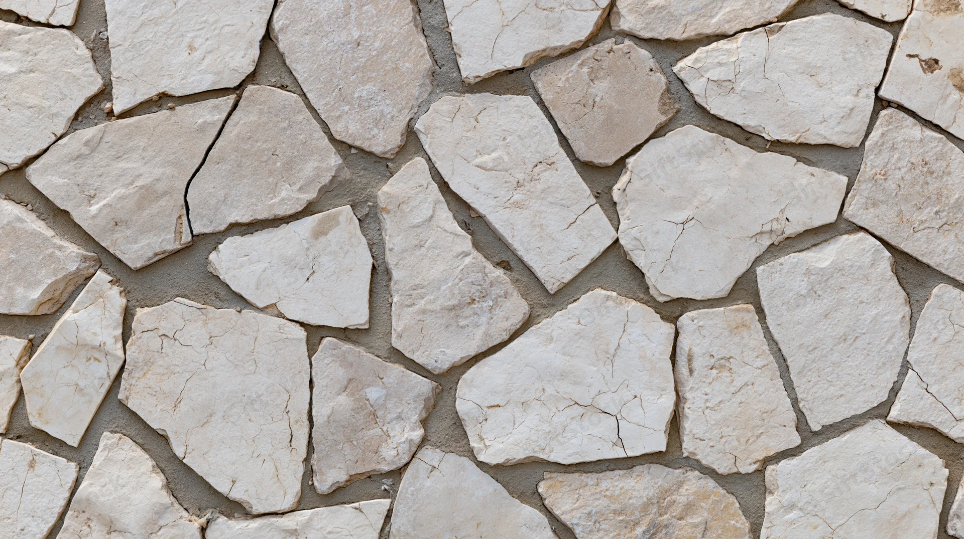 Irregular broken limestone mosaic pavement surface in close-up flat view