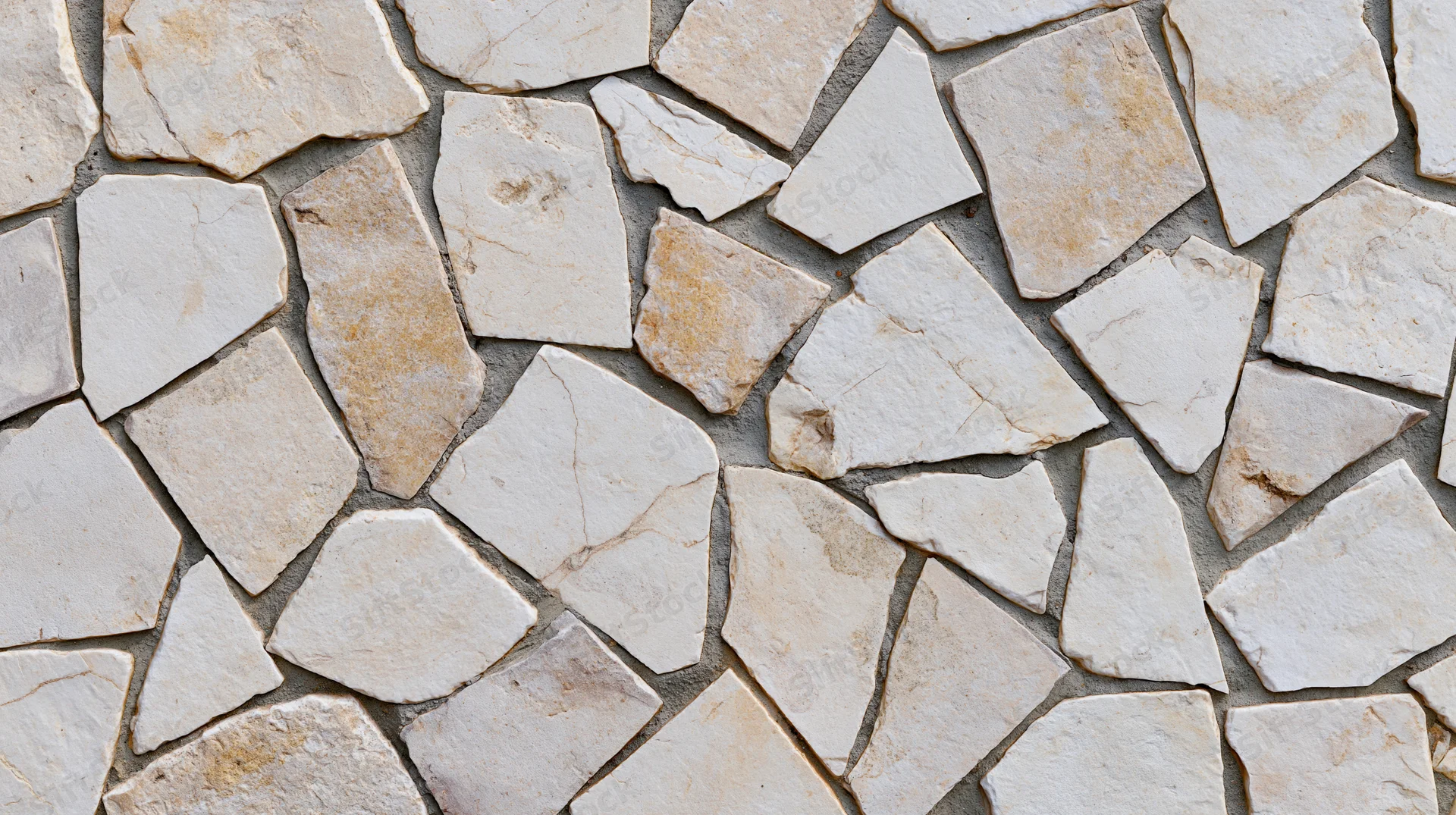 Irregular broken limestone mosaic pavement surface with natural texture and earthy tones