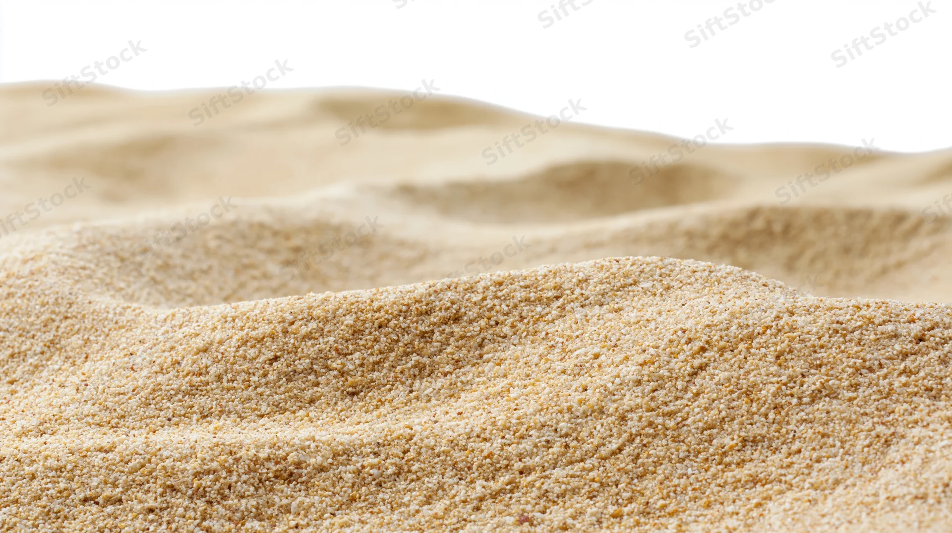 Close-up of dry beach sand with undulating ripples filling the frame against a white background
