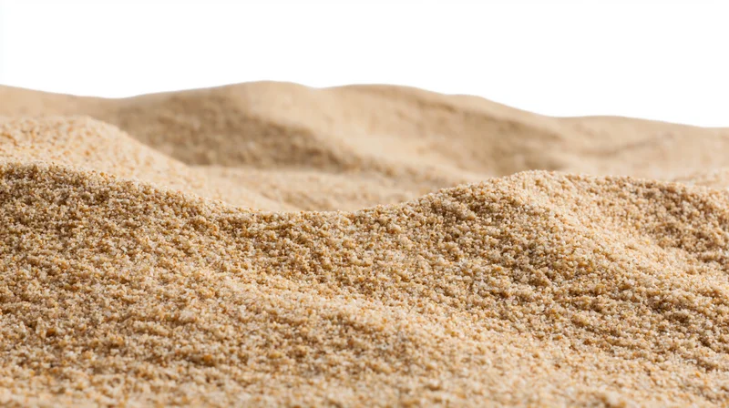 Close-up of dry beach sand texture filling the frame with soft undulations and fine granules