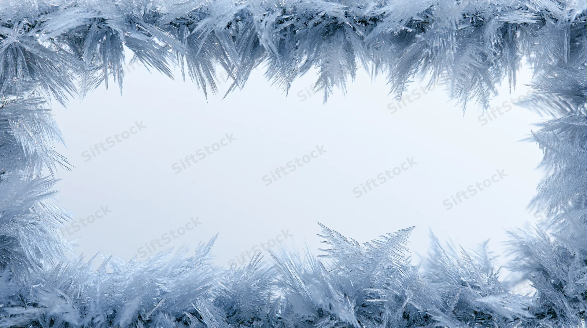 Frost crystal formations arranged as a frame with copyspace in the center