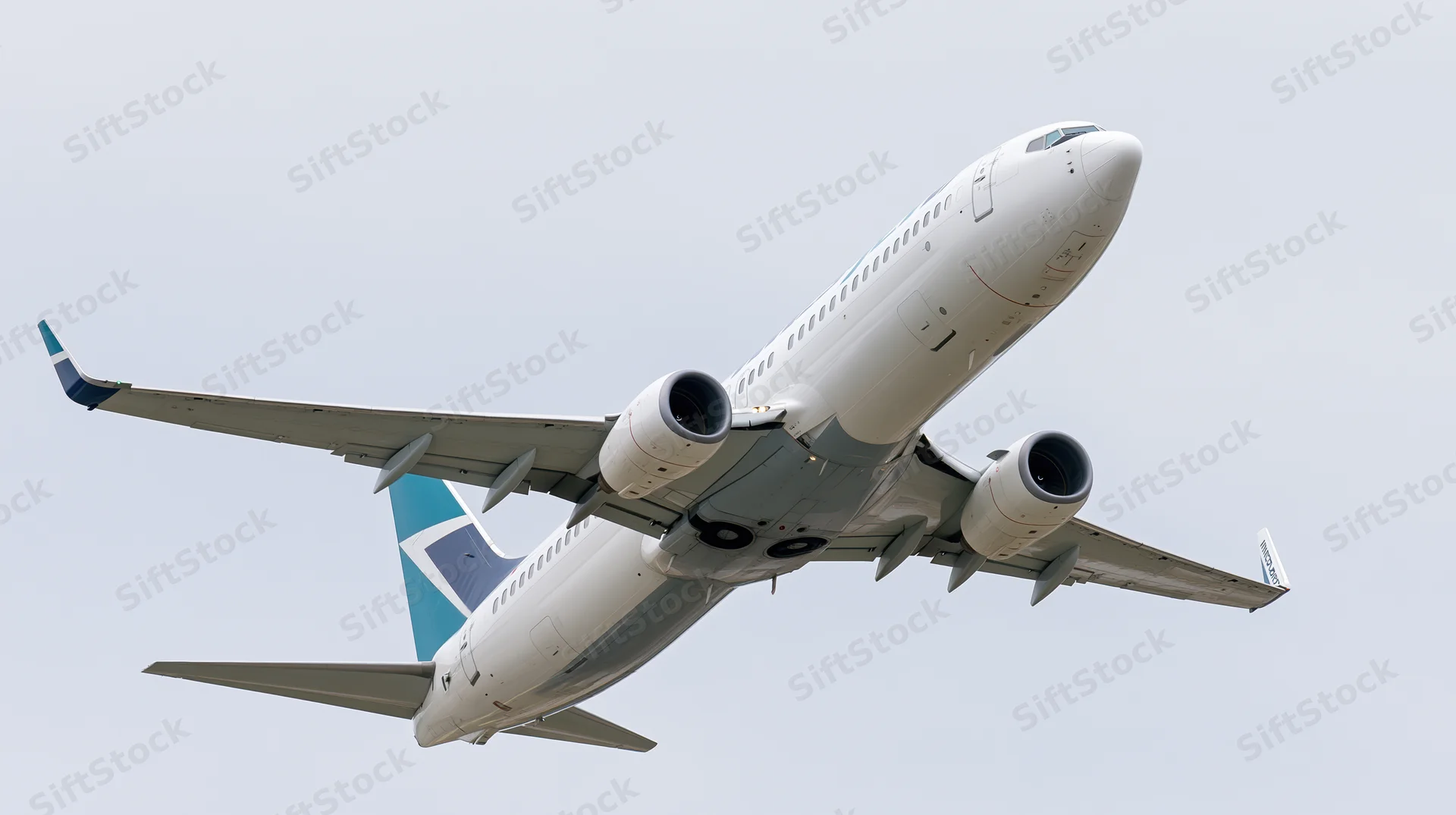 Commercial passenger jet climbing in sky after takeoff
