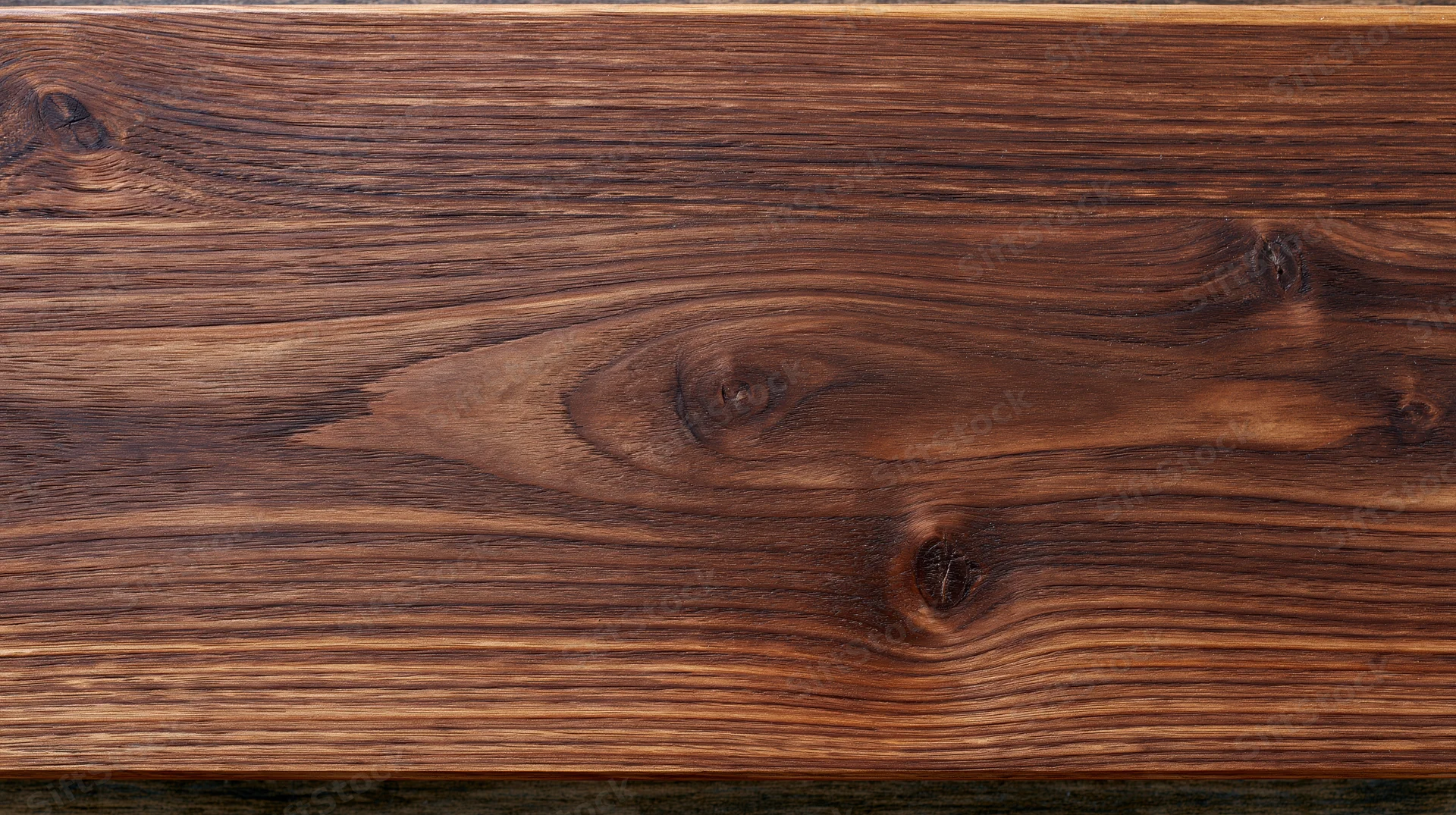 Dark walnut wood plank surface filling the frame flat