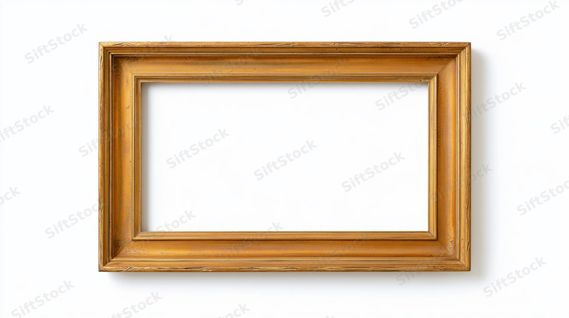 Empty antique gold picture frame with ornate narrow molding on white background
