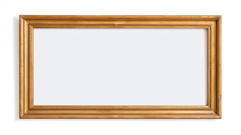 Empty antique gold picture frame with ornate narrow molding on white background