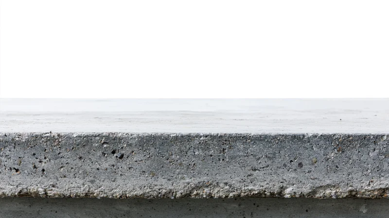 Flat concrete surface at eye level with rough edge and white background
