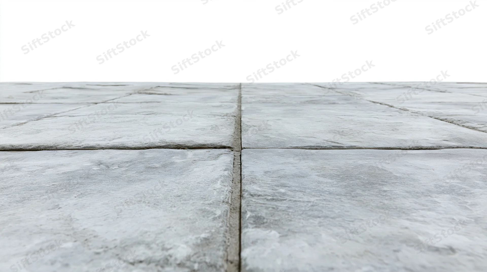 Concrete tile floor receding into perspective from low angle
