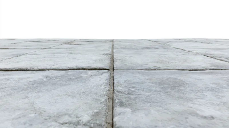 Concrete tile floor receding into perspective from low angle
